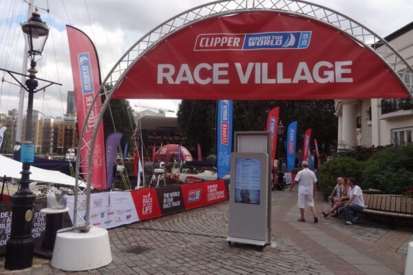 Truss welcome arch on concrete bases at the Clipper Round the World Race Village fanzone