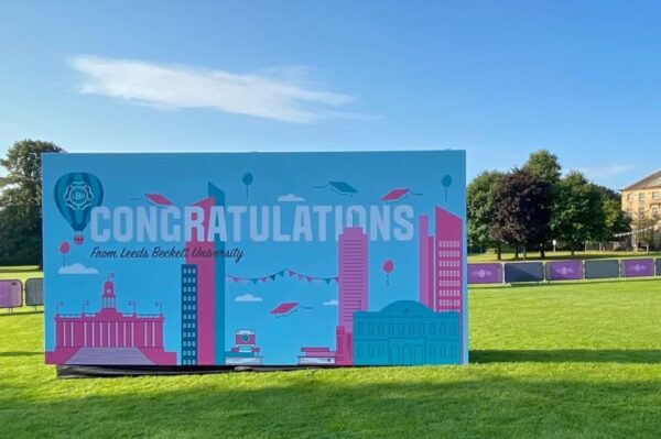 Large super-graphic photo backdrop at Leeds Beckett graduation ceremony