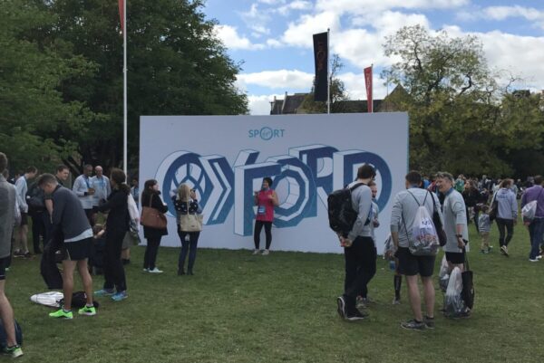 Large super-graphic wayfinding and photo backdrop at the Oxford Half Marathon